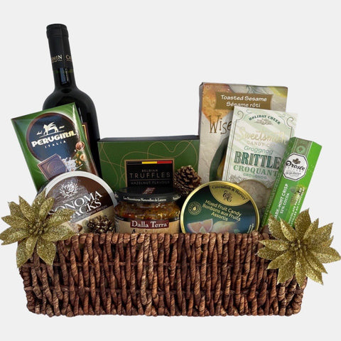 A holiday themed made in Calgary gift basket that includes a bottle of wine and delicious gourmet snacks arranged in a beautiful medium size corn tray.