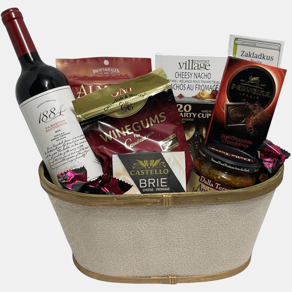 Finest wine gift basket Calgary offers that includes a bottle of wine and delicious gourmet snacks.